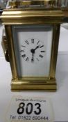 A small brass carriage clock in working order and complete with key
