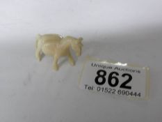 A small old Chinese carved ivory horse