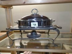 A silver plated food warmer complete with burner