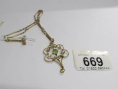 A fine 9ct gold bar & link chain with a gold pendant set peridot and seed pearls