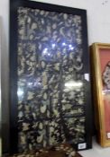 A framed and glazed oriental embroidered panel