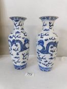 A pair of 19th century Chinese blue and white dragon vases with 4 character Xiang-chi mark (approx