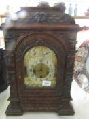 A carved oak clock case with brass dial (no movement)