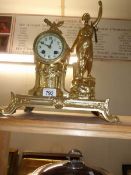 A French gilded mantel clock surmounted figure