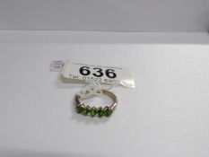 A green garnet 5 stone ring set in gold,