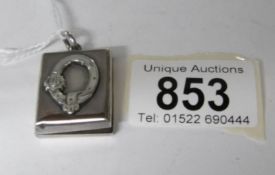 A silver photo locket, 9.