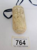 An ivory snuff bottle carved as an elderly gentleman