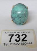 An egg shaped turquoise ring in 18ct gold,