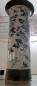 An oriental blue and white pottery umbrella stand