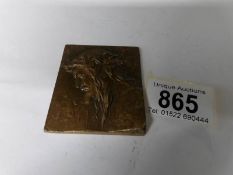 A small bronze plaque depicting Christ,