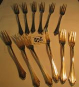 12 silver (800) cake forks,
