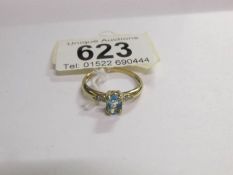 A diamond and topaz single stone ring in gold,