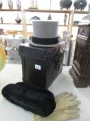 A top hat in leather case together with a fur hat and a pair of kid gloves