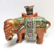 A 19th century famille rose candleholder in the form of an elephant