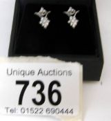 A pair of diamond stud earrings in white gold