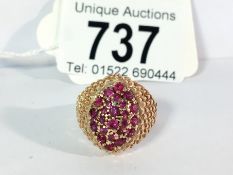 A textured gold ruby set ring, circa 1970's in 14ct gold,