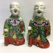 A pair of Chinese pottery laughing boys (He-He boys), early 19th century,