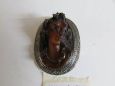 A large oval brooch with relief head of 19th century lady