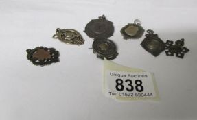 6 silver fobs and a silver brooch