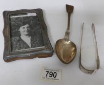 A large silver spoon, London 1839, silver sugar nips,