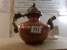 A decorative brass and copper Tibetan teapot