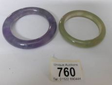 A clear jadeite bangle with flat inside together with a lavender jadeite bangle