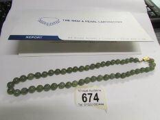 A Grade A Apple Green jadeite necklace of 49 slightly graduated round polished stones, largest 9.