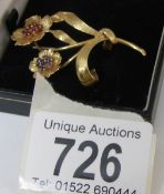 A circa 1970's ruby and sapphire brooch fashioned as flowers in 18ct gold