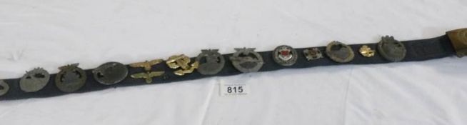 A collection of Nazi badges on belt