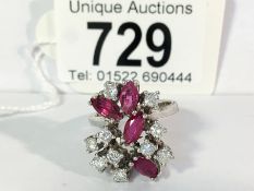 A 1970's ruby and diamond cluster ring in 14ct white gold with over 1ct of diamonds,