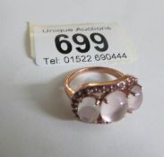 A 3 stone moonstone and amethyst ring marked 925