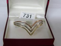 A diamond set bangle in a V shape,