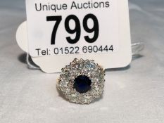 A sapphire and diamond cluster ring, centre sapphire surrounded by 8 diamonds. ETW 1.