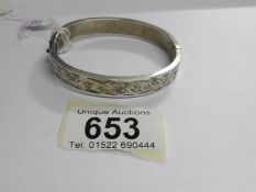 A silver bangle dated 1966, stamped C H Birmingham,