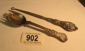 A silver handled button hook and a silver cake spoon,,