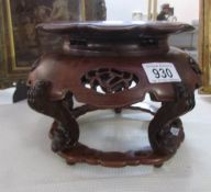 A 20th century Chinese hardwood raised stand with carved and pierced decoration