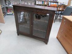 An oak lead glazed cabinet
