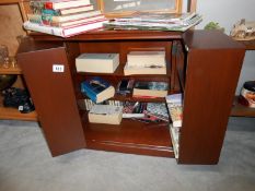 A CD cabinet containing books