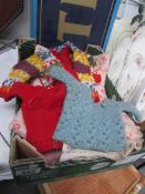 A box of vintage dolls clothes