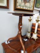 A period oak tripod table,