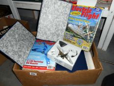 A box of model aircraft magazines and a model aircraft