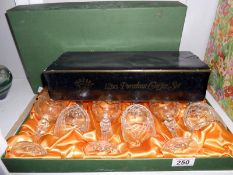 A boxed set of 6 Harrod's wine glasses and a porcelain coffee set