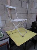 A drop leaf formica top table and a folding chair marked EWS RAF
