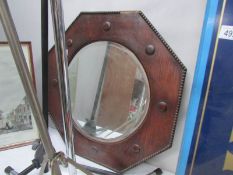 An octagonal oak bevel edged mirror