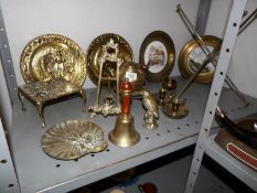 A mixed lot of brass ware including plaques, trivets, bell,