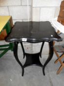 An ebonised occasional table