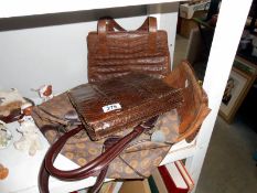 A snakeskin hand bag and 2 others