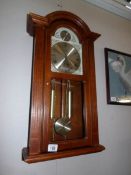 A wooden cased wall clock
