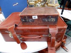 A small vintage suitcase and one other