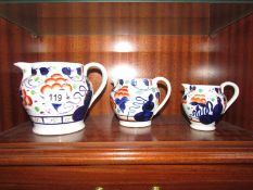 A graduated set of 3 19th century hand painted jugs